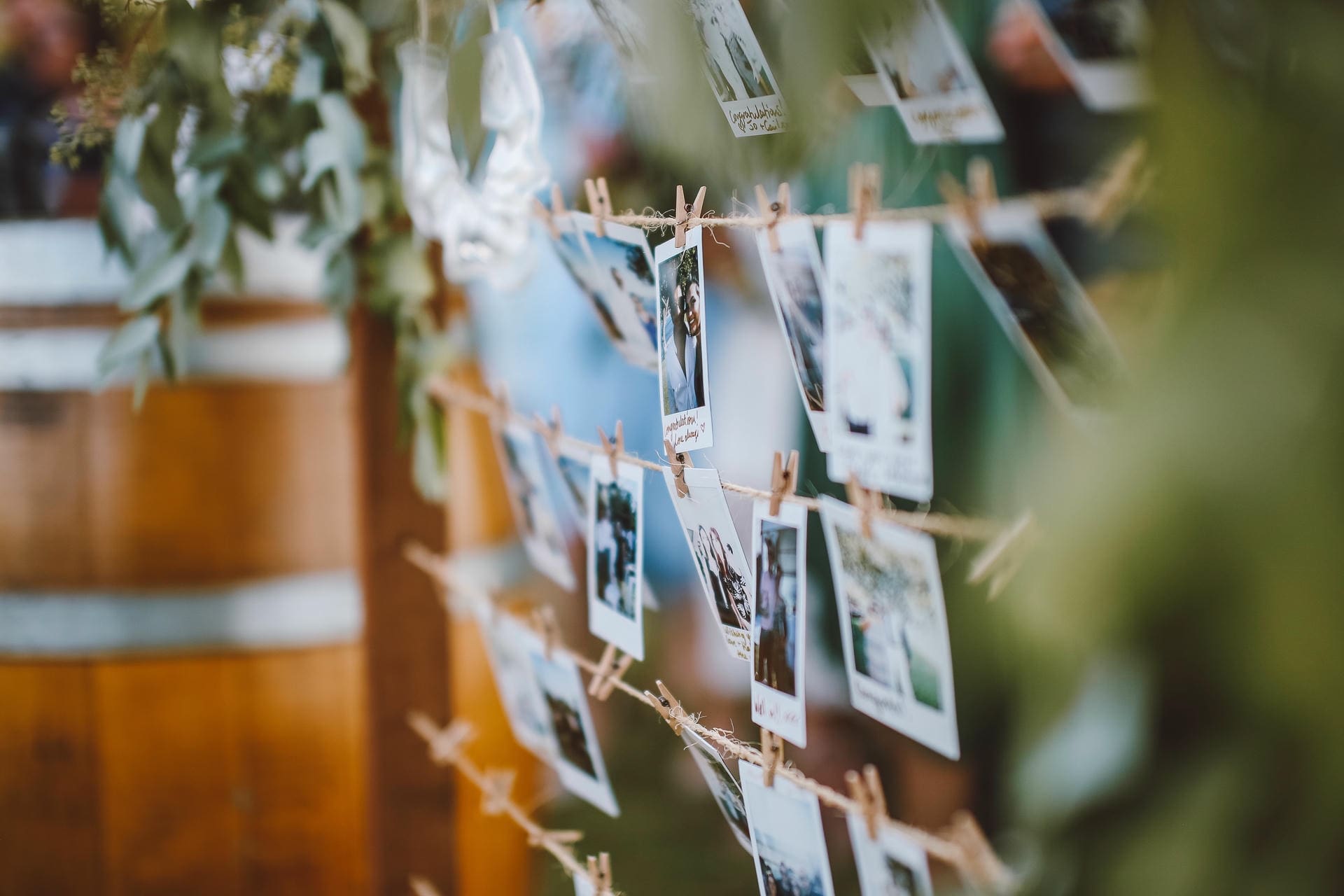 DIY polaroid photo display on twine at a wedding — a detail couples weigh in the all-inclusive wedding venue vs DIY decision