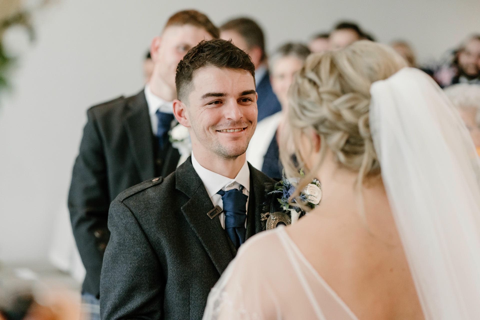 Groom smiling at his bride during their wedding — the kind of moment the right Iowa wedding reception venue is built around