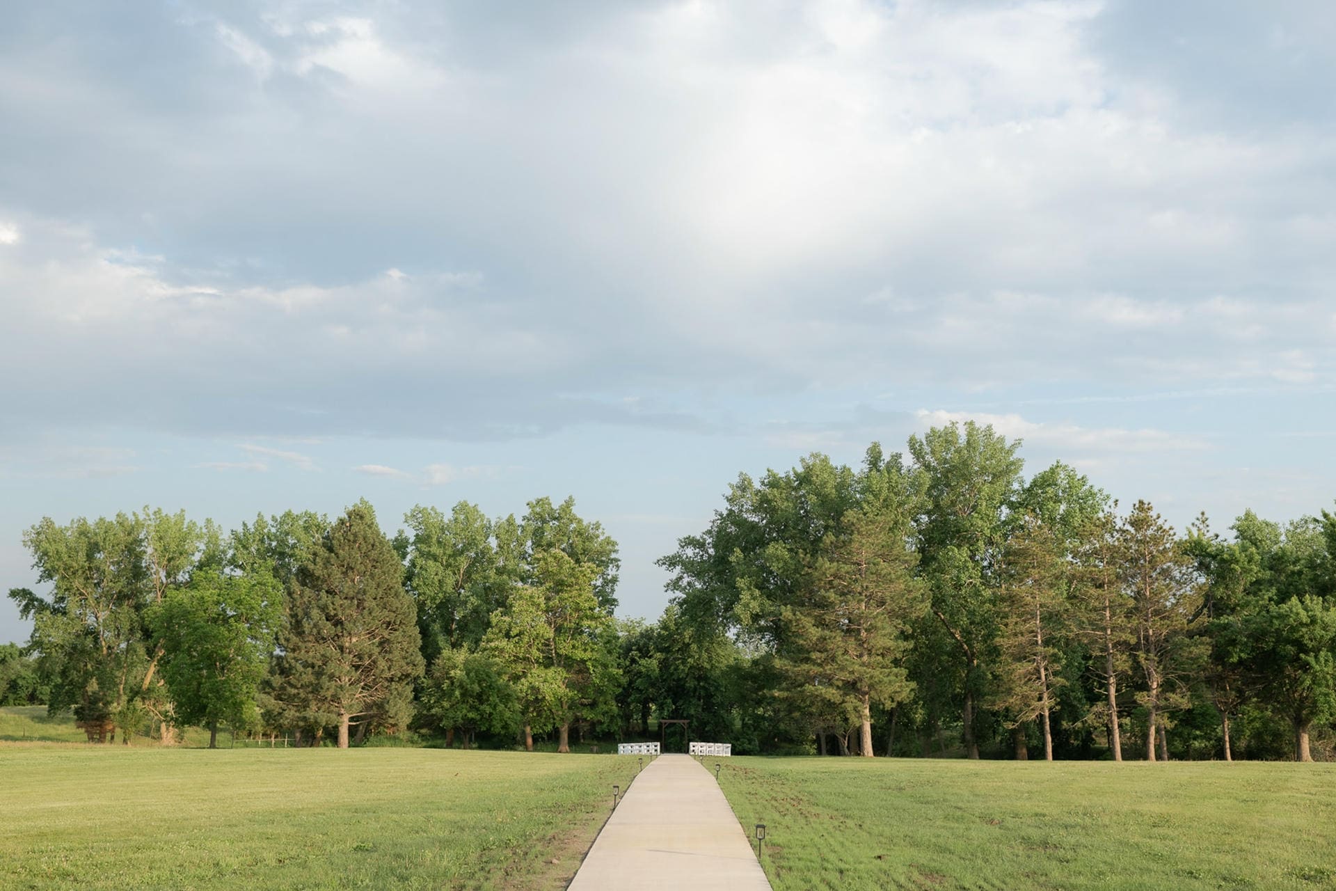 Outdoor ceremony walkway and open sky at The Era, a wedding weekend venue in western Iowa