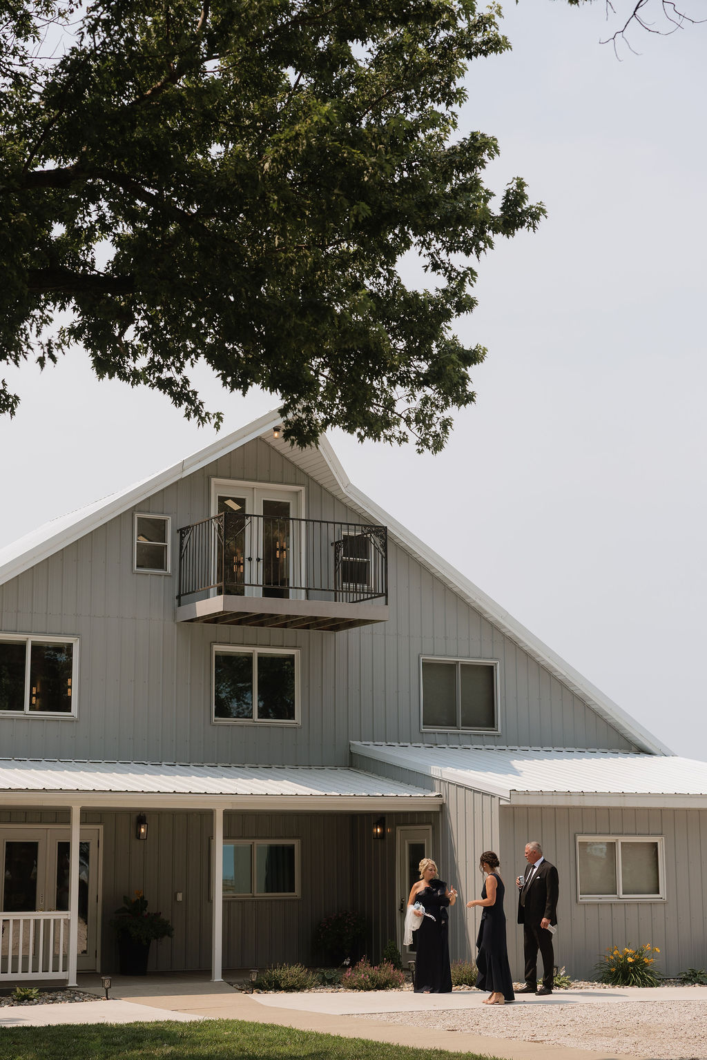 Iowa character wedding venue exterior with restored barn and bridal loft balcony