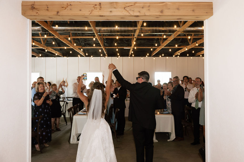 Bride and groom entering their all-inclusive Iowa wedding reception at The Era